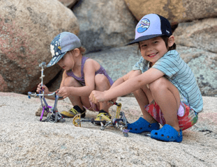 Kids bouldering on granite above the valley